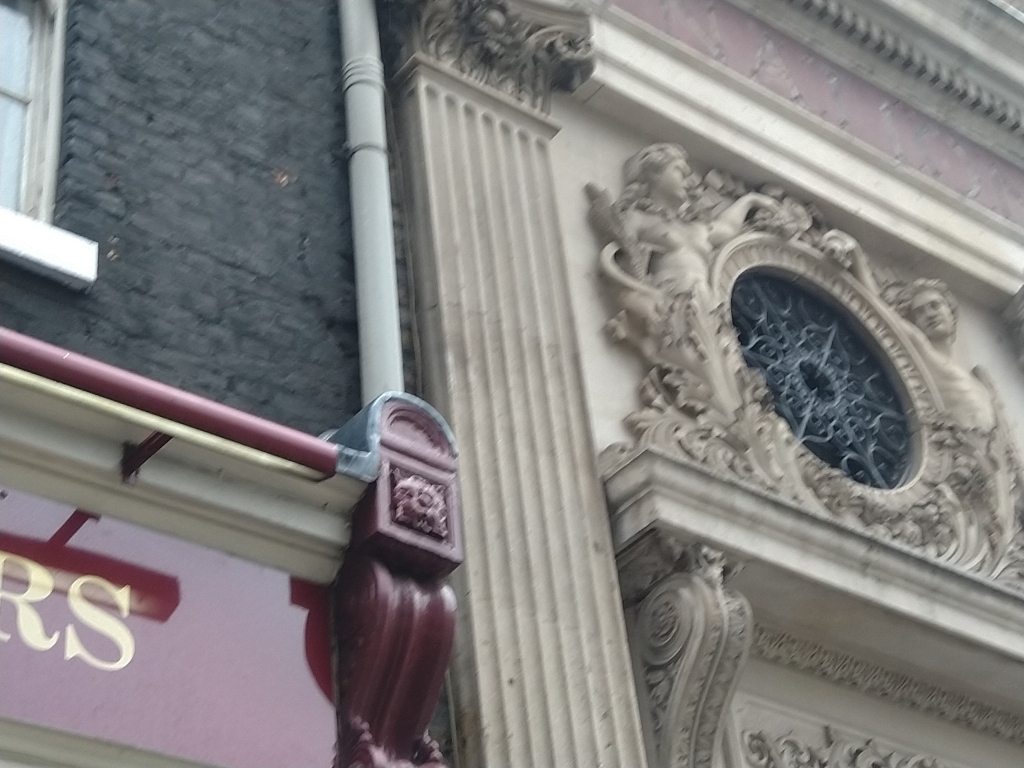 Classical stucco sculpture above jewellers.